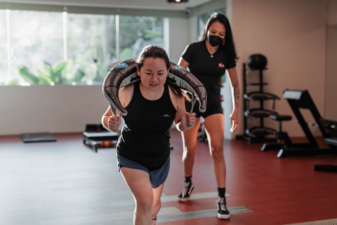 Young Asian Women doing Intense Cardio Exercise, guided by a Female Personal Trainer